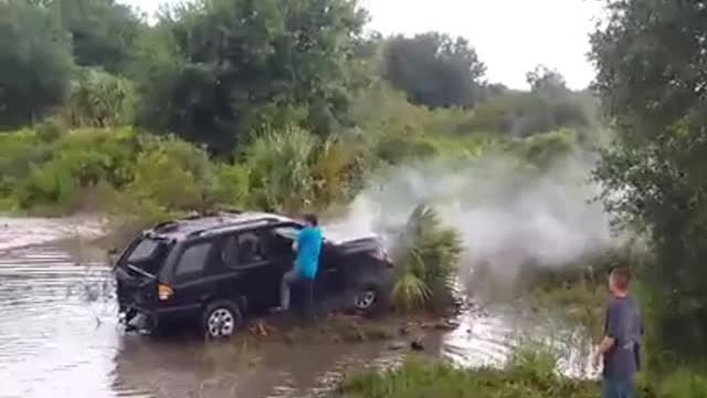 Stuntman in Training Jumps SUV Over a Creek