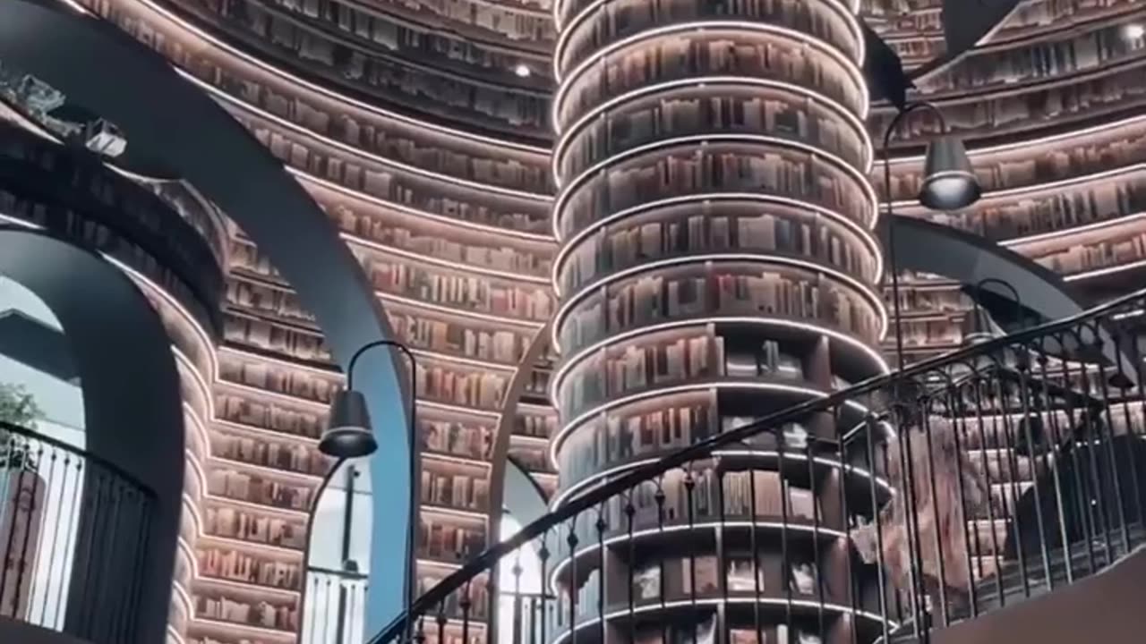 A SURREAL EXPERIENCE IN SOUTHWEST CHINA BOOK SHOP SPIRALING STAIRCASE ~CURVED ARCHWAYS~STRATEGICALLY PLACED MIRRORS CREATING AN ILLUSION OF INFINITY