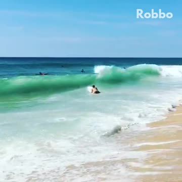 Guy surfboard runs into ocean beach hit by big wave
