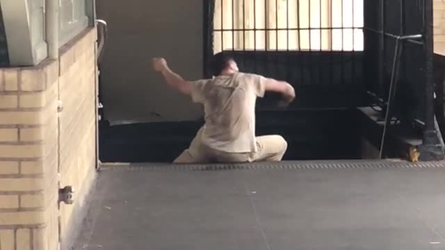 Man in brown outfit dancing on the floor