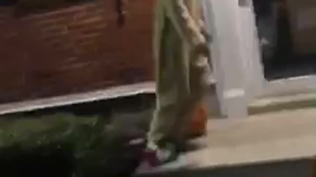 Guy yellow onesie front flips into bushes night time