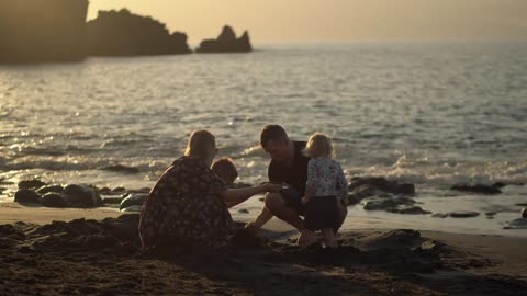 Parents with two young children at the beach