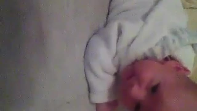 Baby struggles to roll