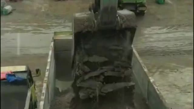 dump truck queue at sand mining