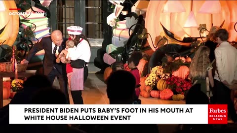 At the White House Halloween event, Biden literally put a baby’s foot in his mouth! 🤬