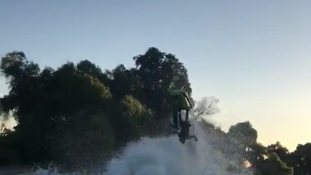 Guy in green jet ski flips backwards