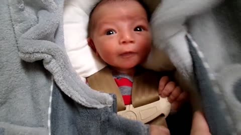 Adorable newborn baby makes silly faces