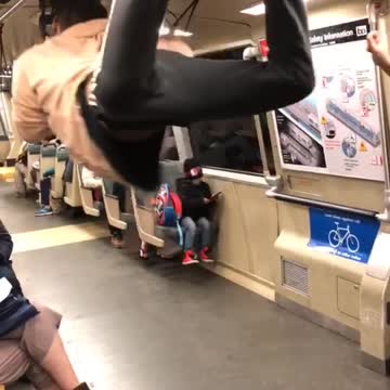 Man pink sweater black and white pants dancing train