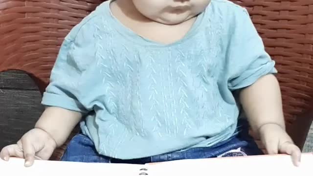 Cute baby reading a book