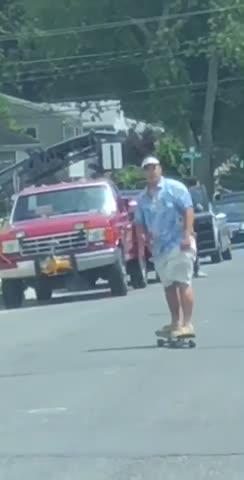 Blue shirt visor skating down street