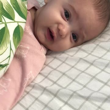 Adorable baby smiles and stretches