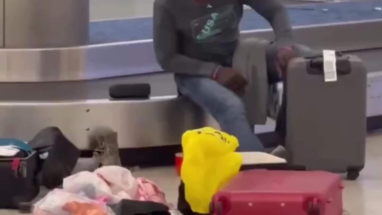 Thief Going Through Airport Luggage In Public