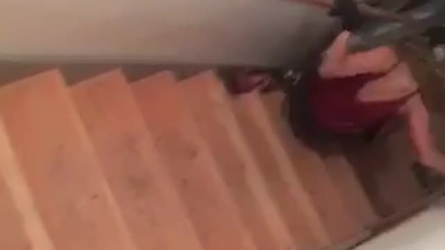 Red shirt girl skis down stairs