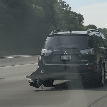 Car bumper hanging on the road