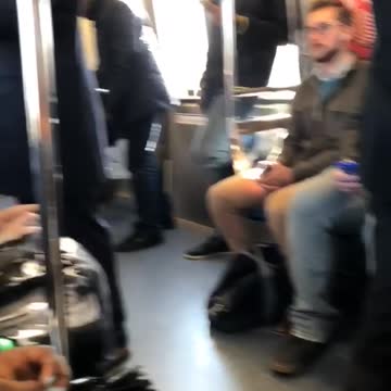 Guy puts blue towel on head to sleep on subway