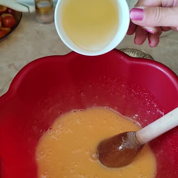 Adding oil to eggs with sugar