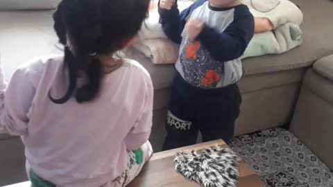 Little Ahmed and his sister talking to each other and playing