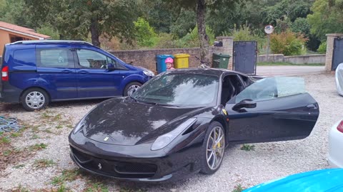 A little girl plays with expensive cars