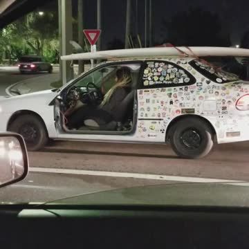 White car white surfboard has no door