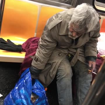 Old man smoking on subway train, drinks bottle of snapple