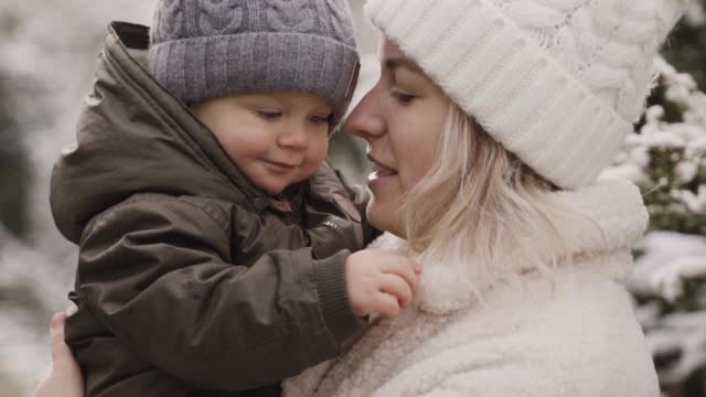 A Woman Kissing and Playing with her Baby