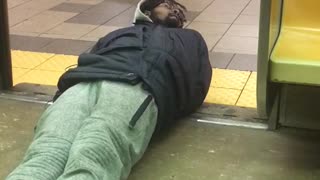 Man on floor crawls falls off subway