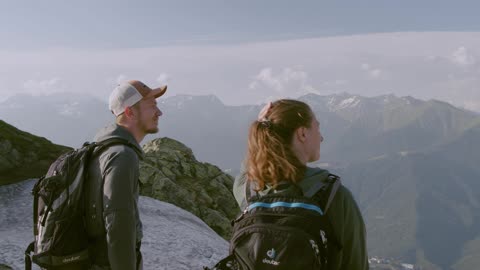 A Couple Seeing A Scenic View From The Mountain Top