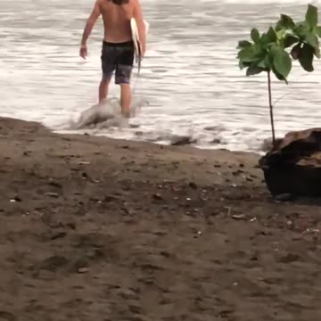 Guy long hair surfboard finless