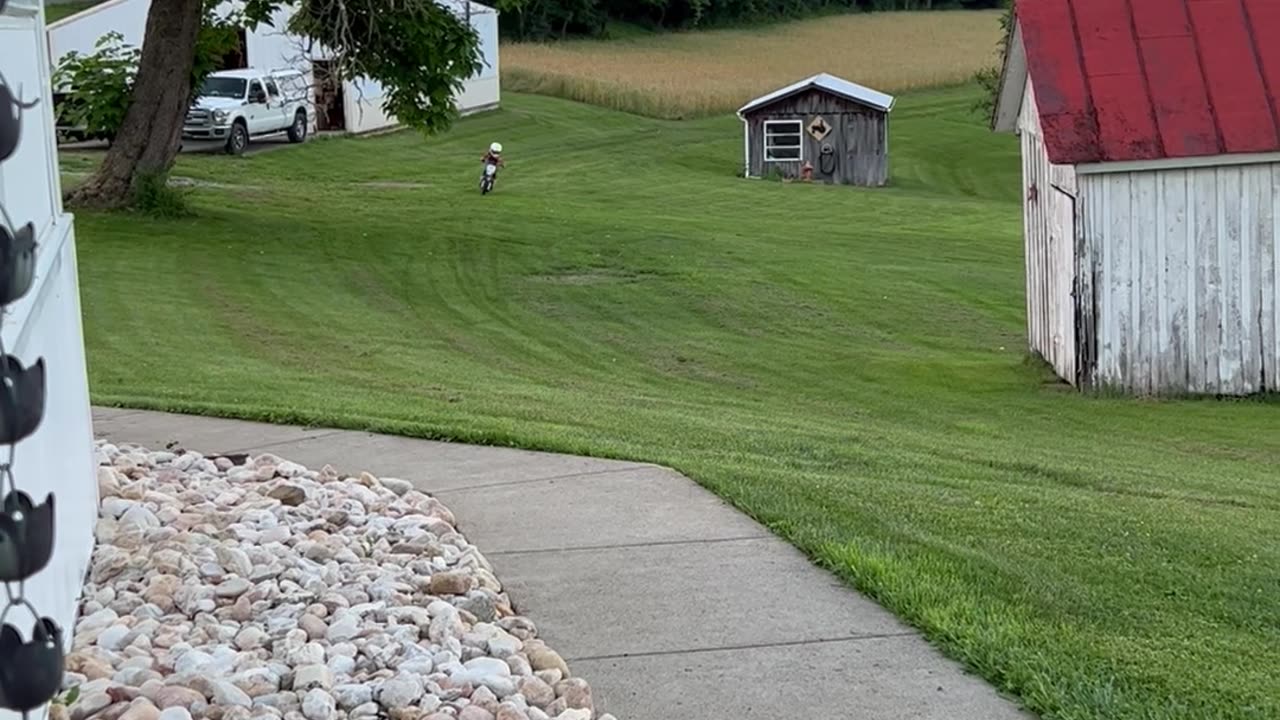 Little Motorcycle Racer Rides in the Backyard