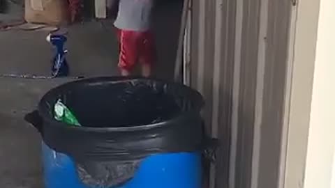 Boy in red shorts yells when dad asks him to come over