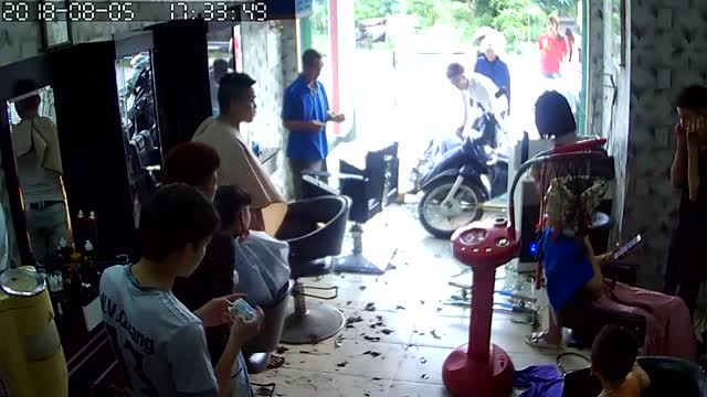 Out of Control Scooter Smashes Into Barbershop