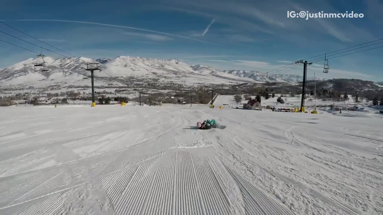 Girl green pants pink helmet scorpion snow boarding