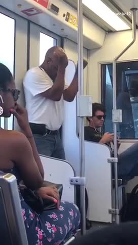 Man white t shirt dancing by train door