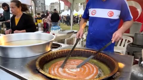 the giant ring dessert being made at the festival.