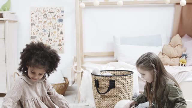 Two Young Girls Playing With Wooden Dinosaur Toys With Wheels