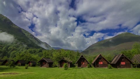 Wooden Cabins For Travelers Built On The Mountains Valley