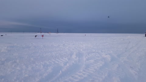 helicopter landing in the tundra