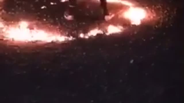 Guys fight in a circle of fire