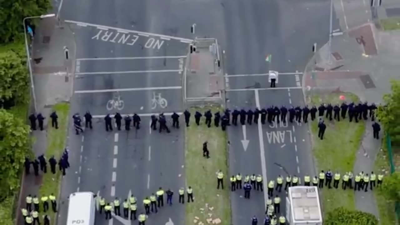 "Drone Footage: Irish Police Charge Locals Protesting Asylum Seekers' Center in Coolock"