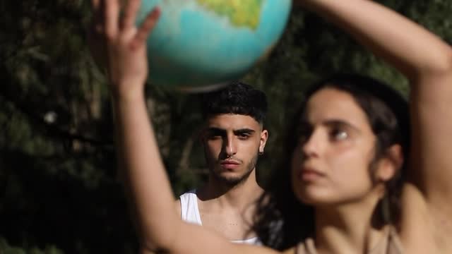 A Woman Dancing While Holding a Globe