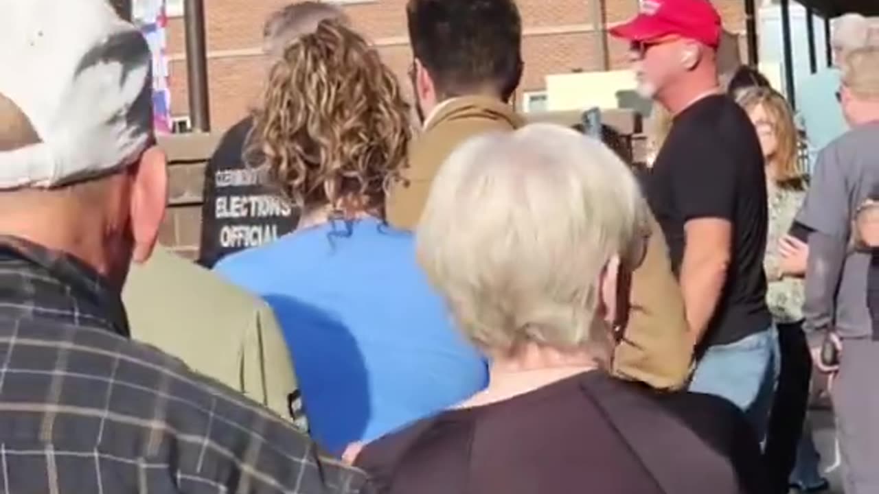 The election official tried to get him to take his Make America Great Again hat off