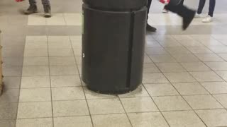 Person in donald trump mask, american flag bodysuit climbs on top trash can