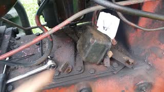 Repairing rubber insulators on a tractor voltage regulator.