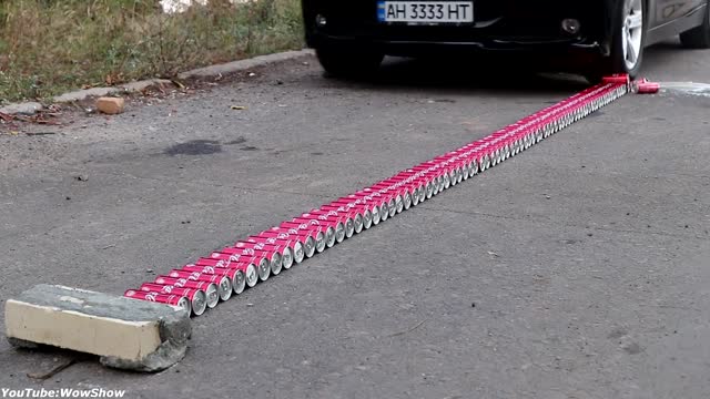 Driving a car over Coca-Cola cans