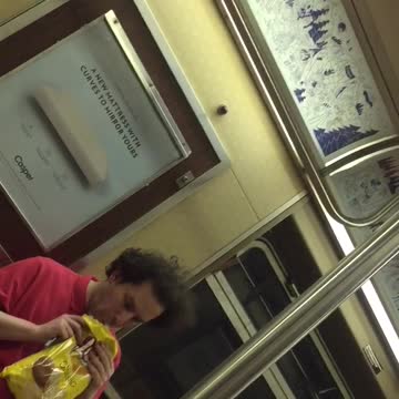 Guy red shirt eating chips out of yellow bag weird