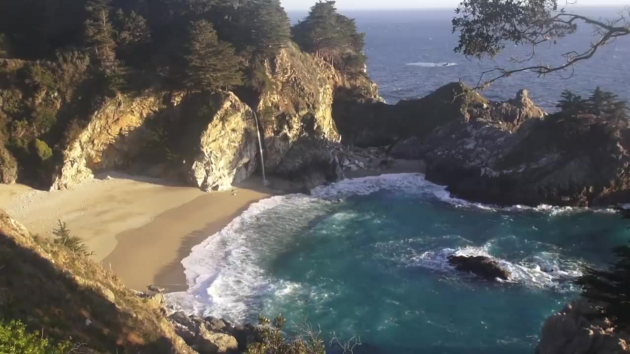 Relaxing video of a Waterfall on an Ocean Beach at Sunset