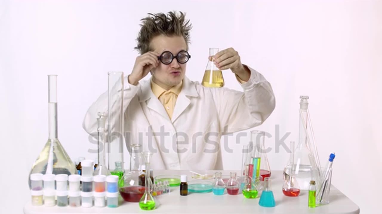 funny scientist among flasks with multi-colored liquid!