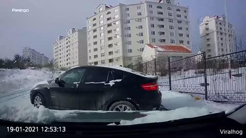 Driver Reverses Away From Sliding Car