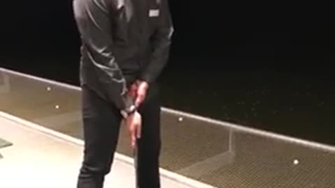 Guy hits golf ball it hits him on legs