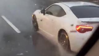 Woman Drives Along Watching a Movie